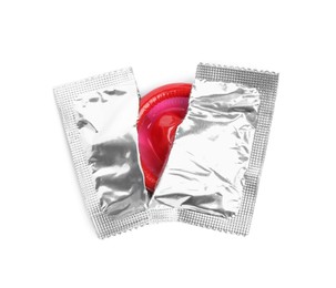 Photo of Torn condom package isolated on white, top view. Safe sex