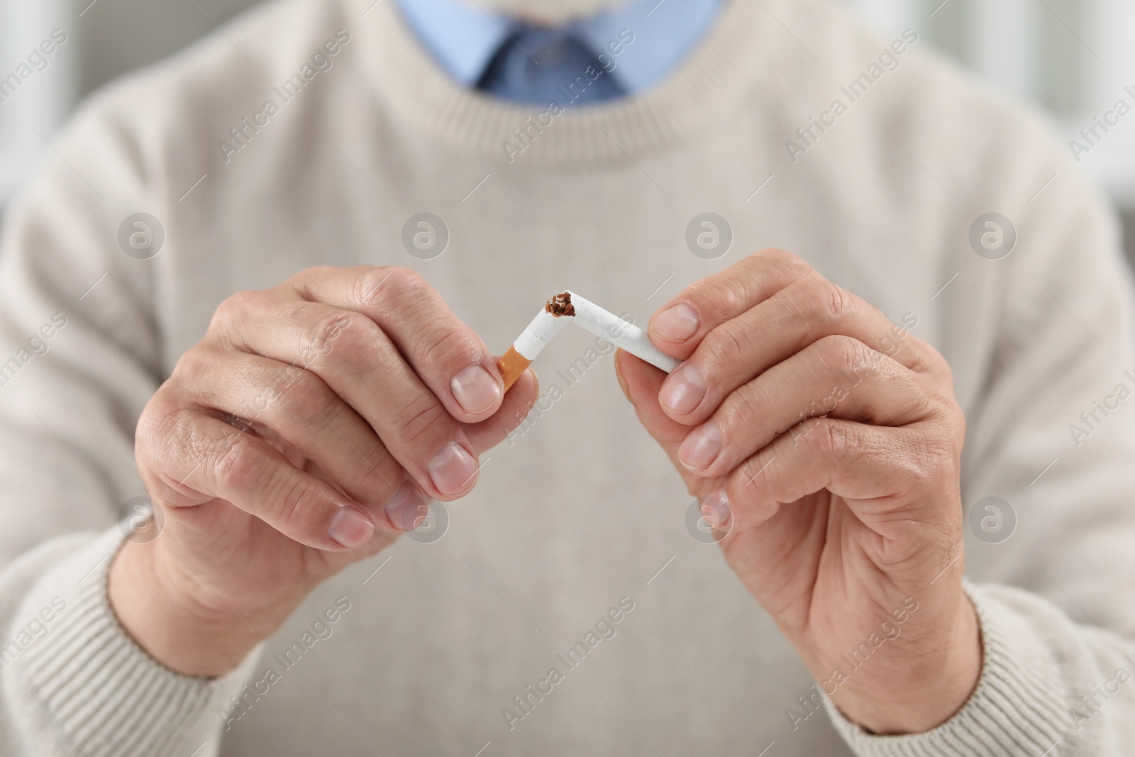 Photo of Stop smoking concept. Man breaking cigarette, closeup