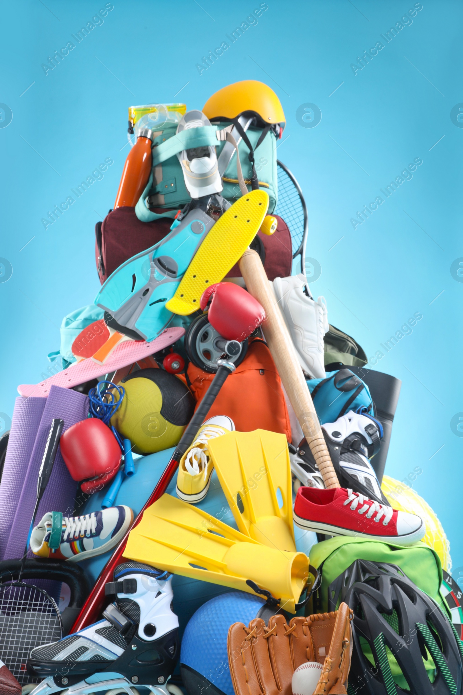 Photo of Many different sports equipment on light blue background