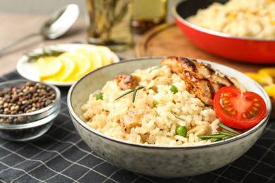 Photo of Delicious chicken risotto with tomato on table, closeup