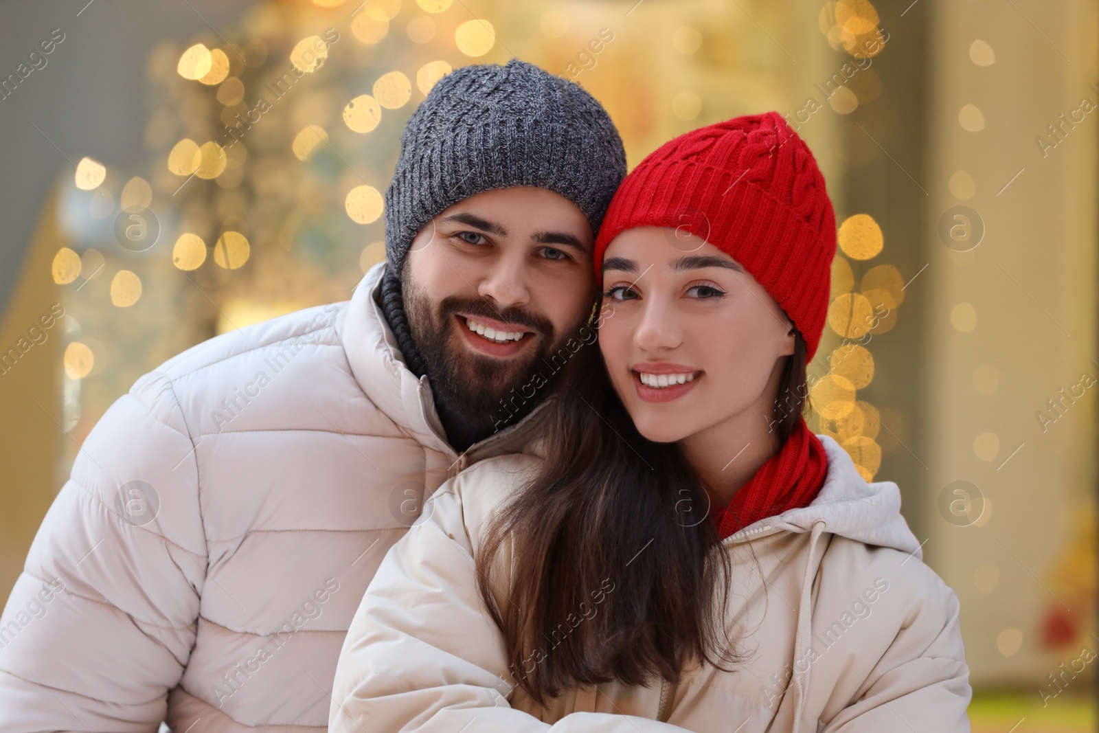 Photo of Portrait of lovely couple outdoors against blurred lights outdoors