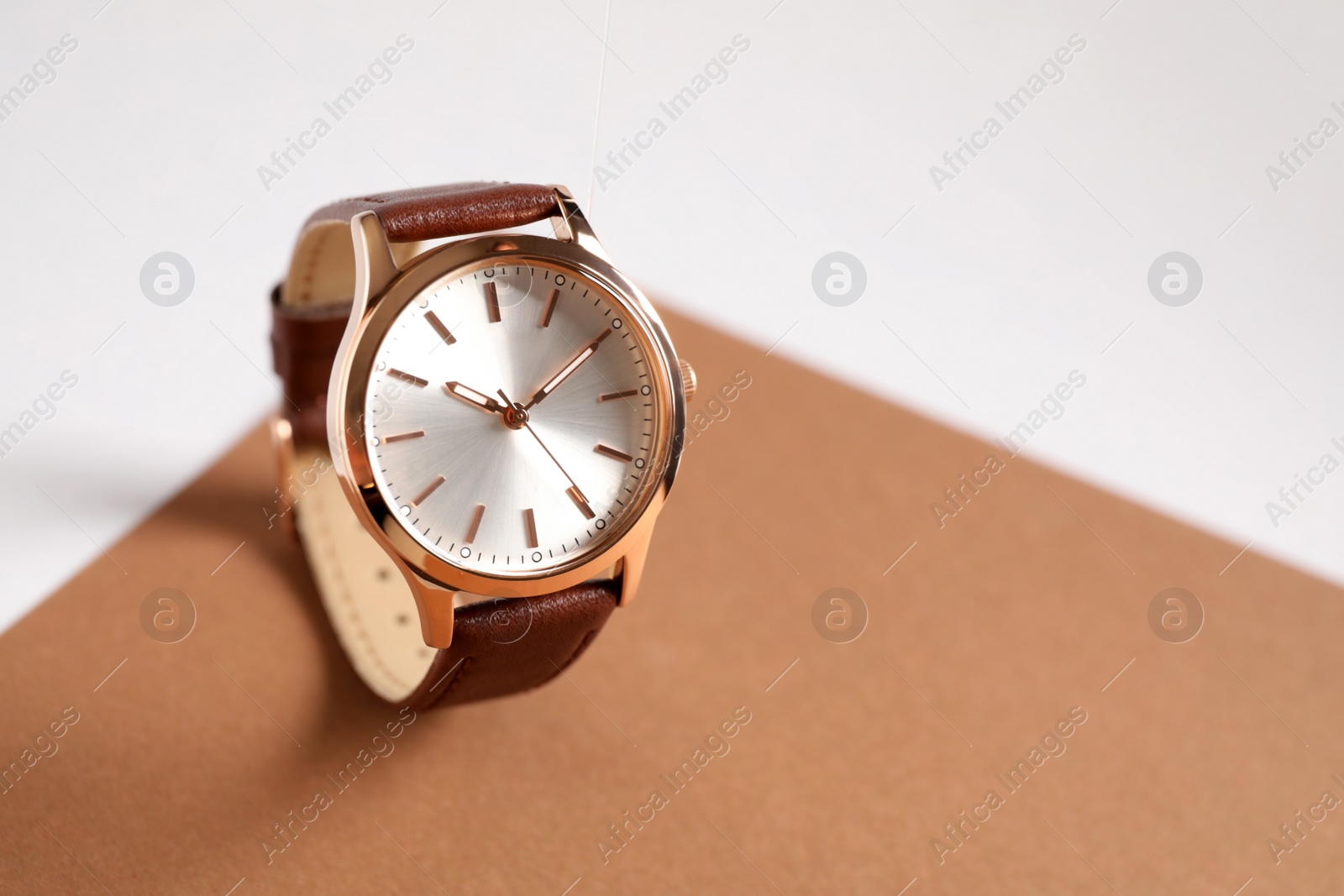 Photo of Luxury wrist watch on color background. Space for text