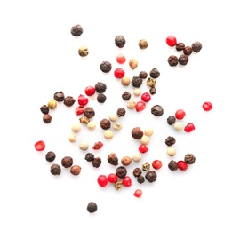 Mix of different pepper grains on white background, top view