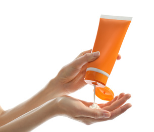 Woman applying sun protection cream on hand against white background, closeup