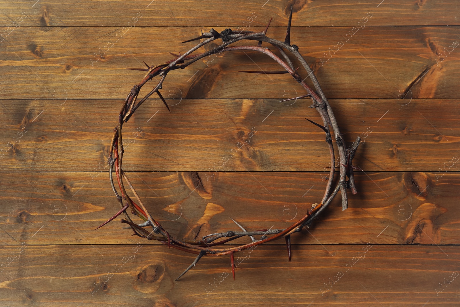 Photo of Crown of thorns on wooden table, top view. Easter attribute