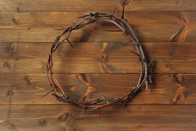 Crown of thorns on wooden table, top view. Easter attribute