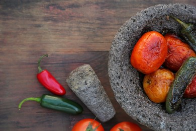 Ingredients for salsa sauce, pestle and mortar on wooden table, flat lay. Space for text