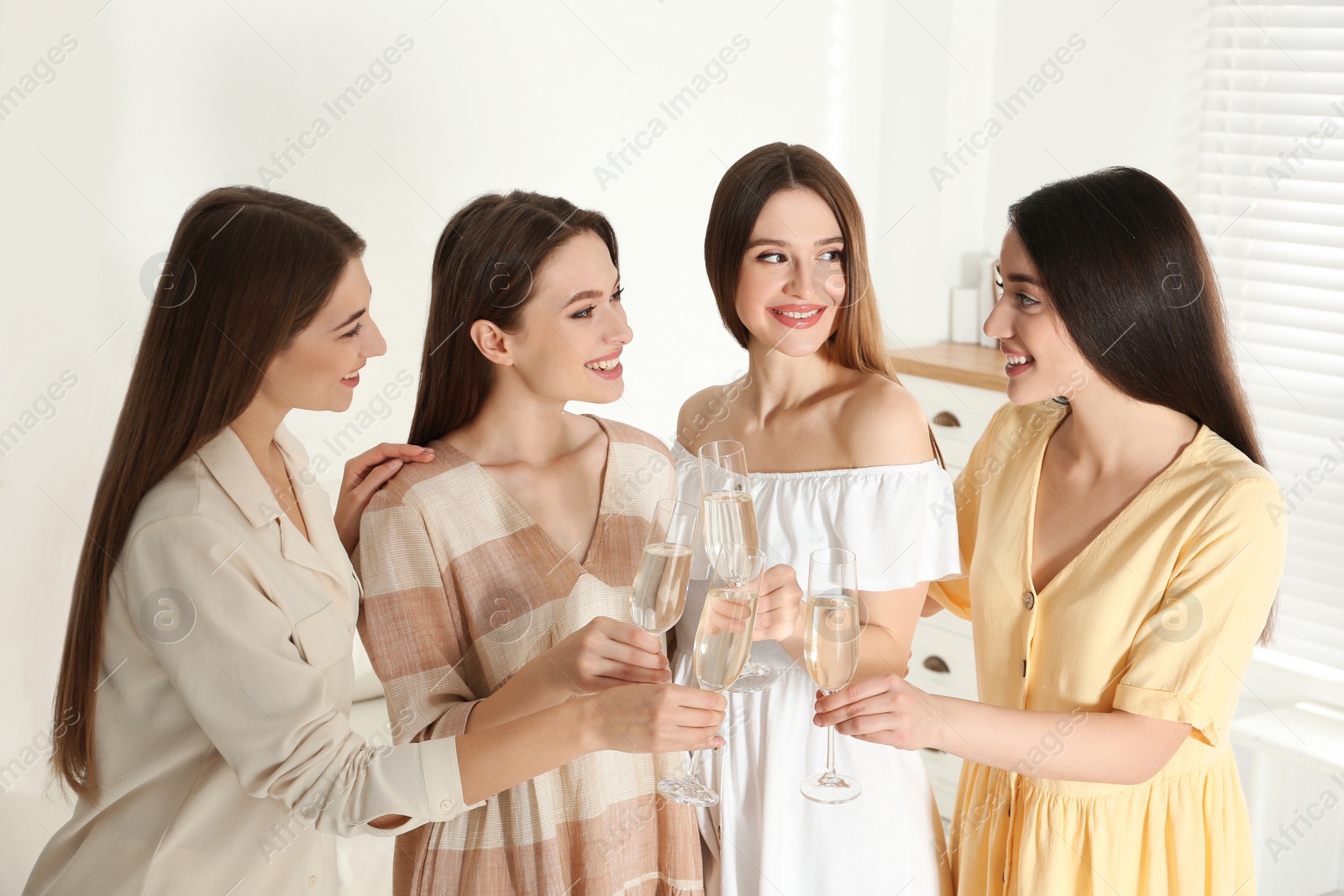 Photo of Beautiful young ladies toasting indoors. Woman's Day