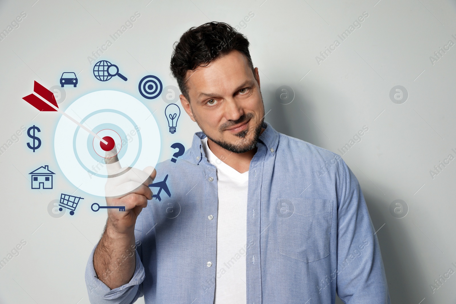 Image of Man and dart board on light background