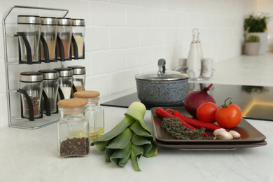 Photo of Fresh vegetables on white countertop in kitchen