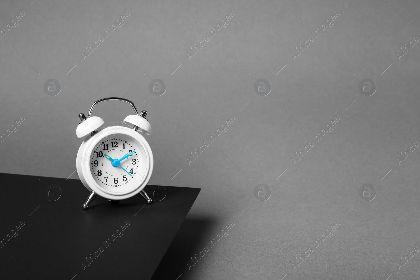 Photo of Alarm clock on dark background. Space for text