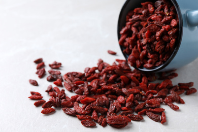 Photo of Dry goji berries on light table, closeup