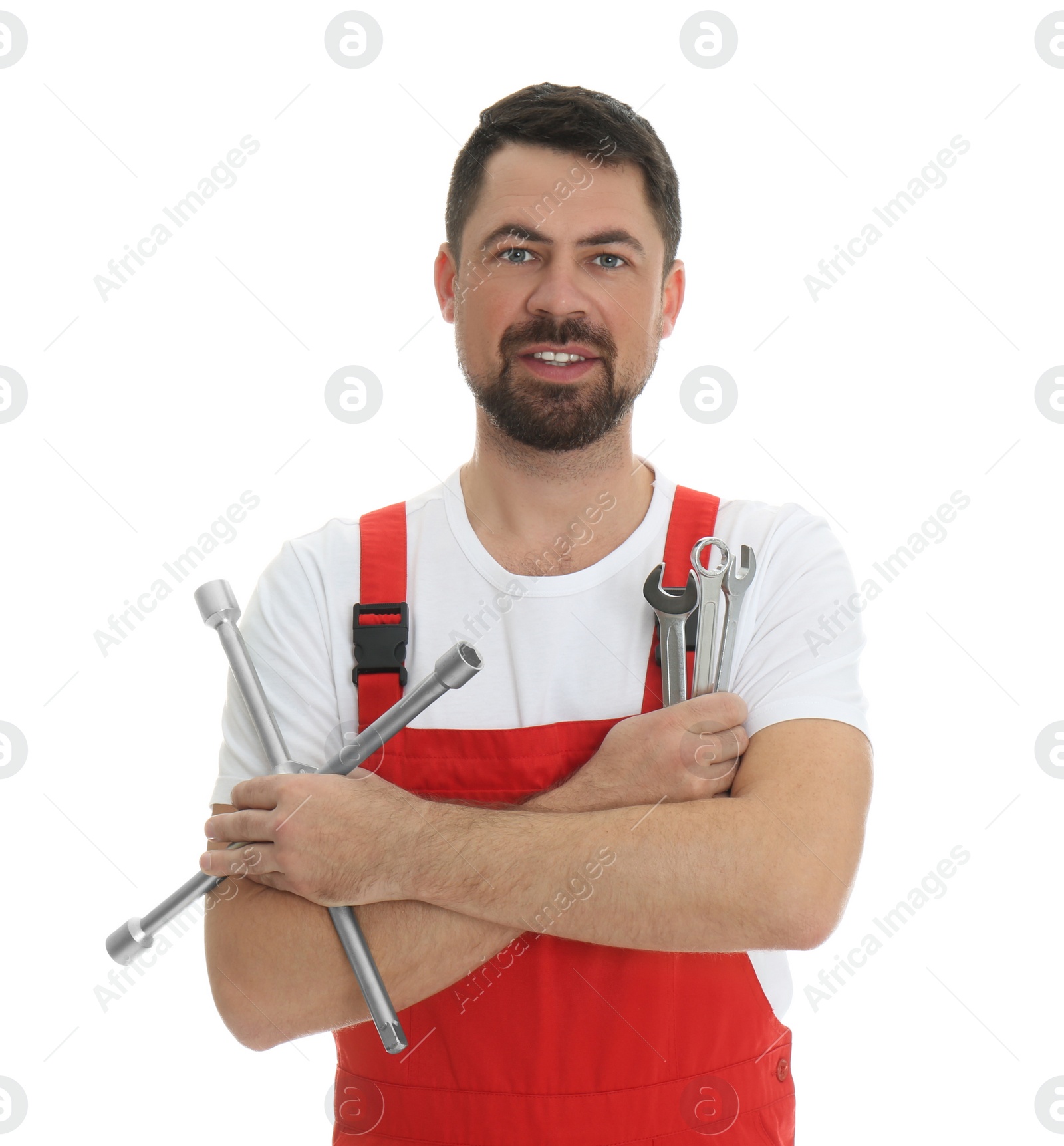 Photo of Portrait of professional auto mechanic with wrenches on white background