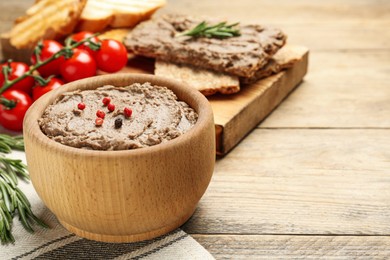 Tasty liver pate with pepper on wooden table, space for text