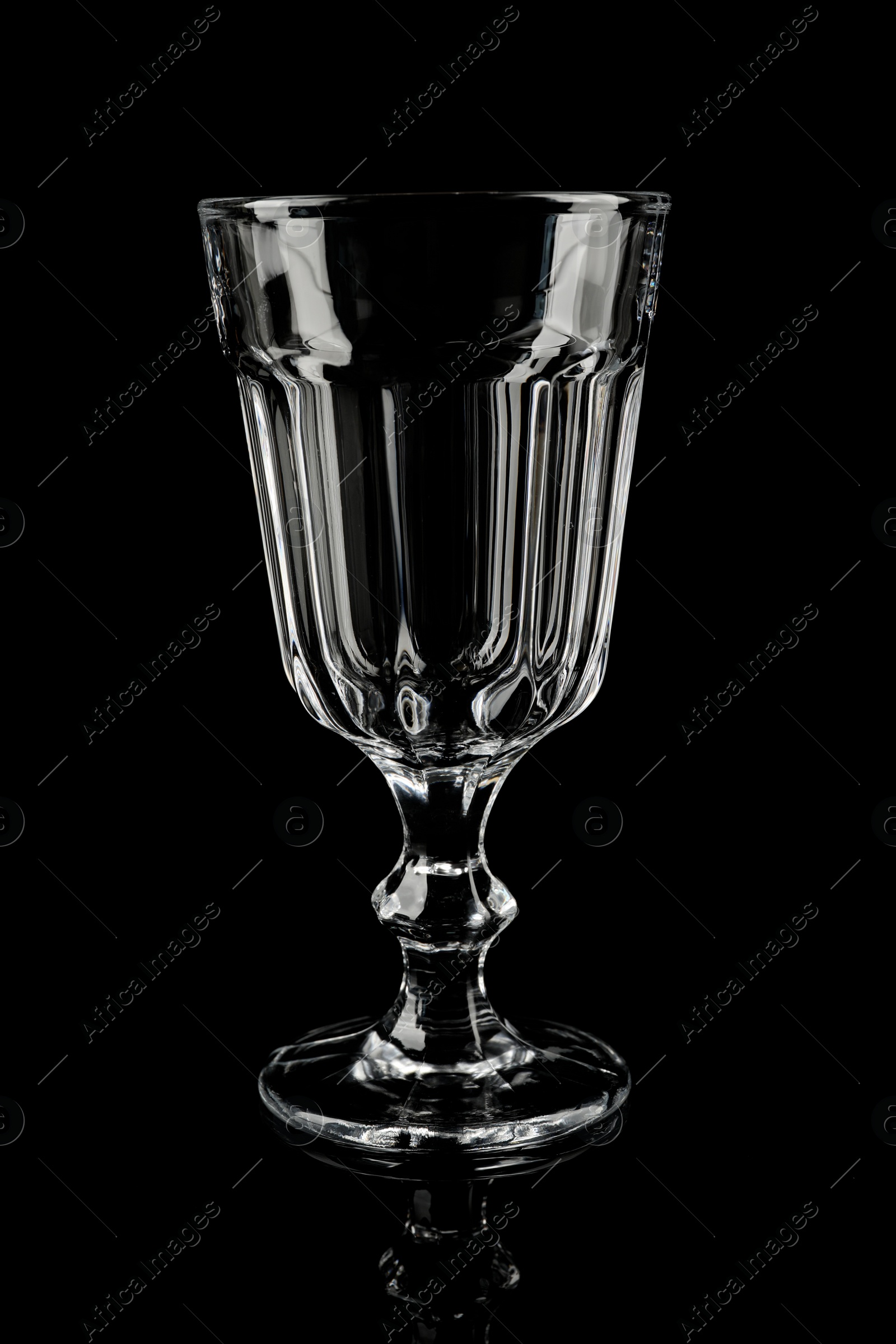 Photo of Clean empty cocktail glass on black background