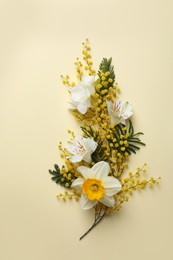 Photo of Beautiful floral composition with mimosa flowers on beige background, flat lay