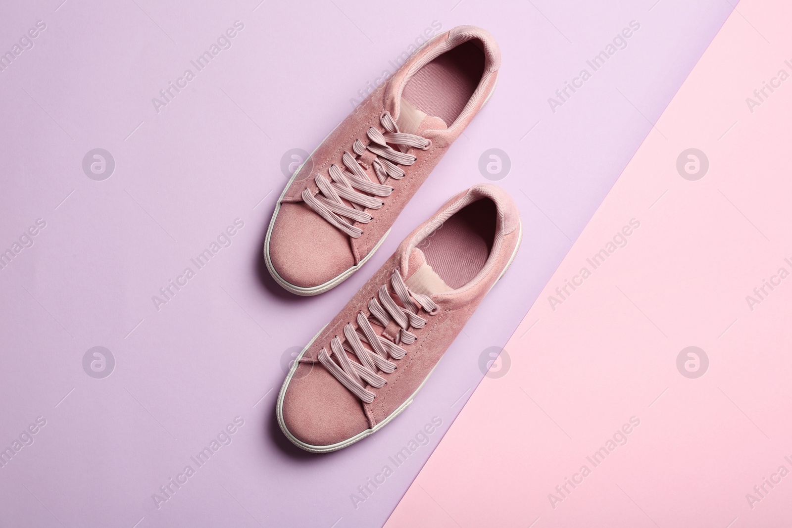 Photo of Bright stylish shoes on color background, top view