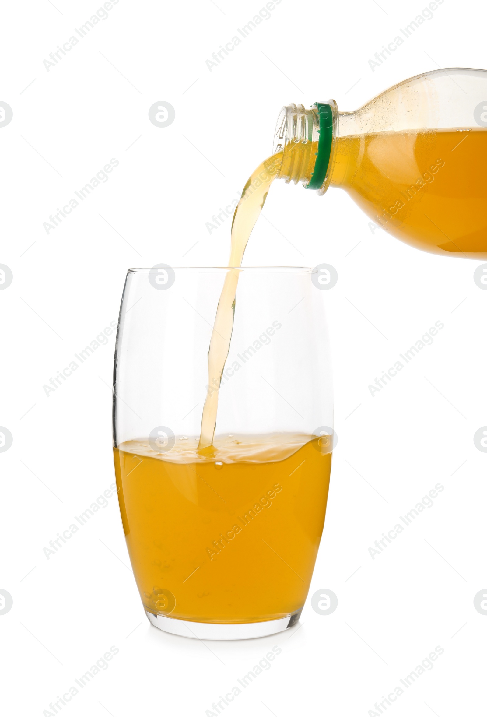 Photo of Pouring delicious orange soda water from bottle into glass on white background