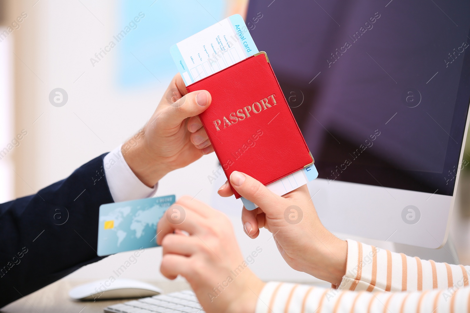 Photo of Male manager giving passport with ticket to client in travel agency, closeup