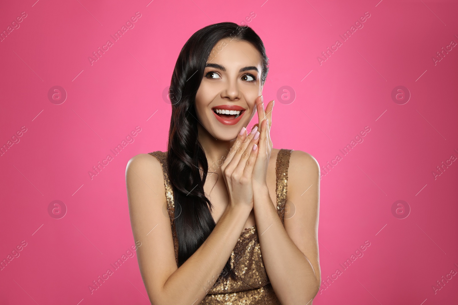 Photo of Portrait of surprised woman on pink background