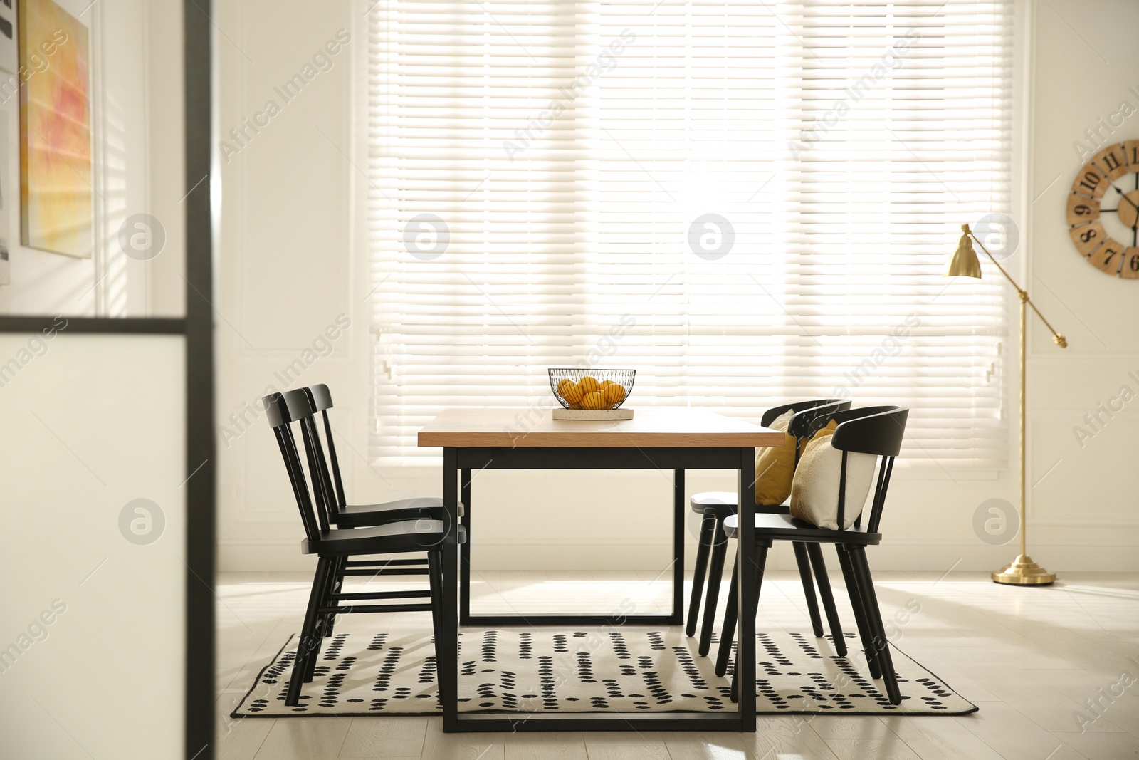 Photo of Stylish wooden dining table and chairs in room. Interior design