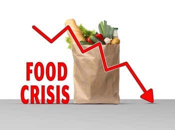 Image of Global food crisis concept. Global food crisis concept. Kraft paper bag with different fruits, vegetables and decline graph on grey table against white background