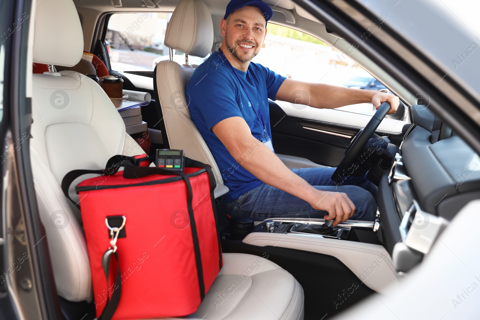 Photo of Male courier with thermo bag in car. Food delivery service