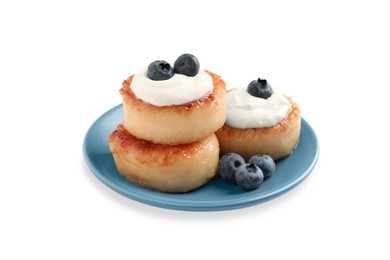 Photo of Delicious cottage cheese pancakes with blueberries, honey and sour cream on white background