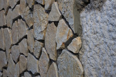 Photo of Texture of old stone wall as background, closeup