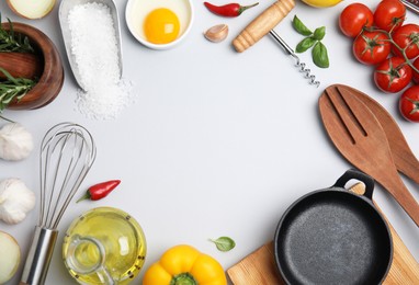 Photo of Frame made of cooking utensils and fresh ingredients on white background, top view. Space for text