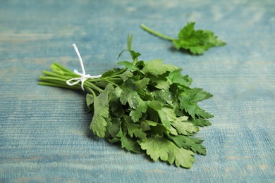 Photo of Bunch of fresh green parsley on wooden background