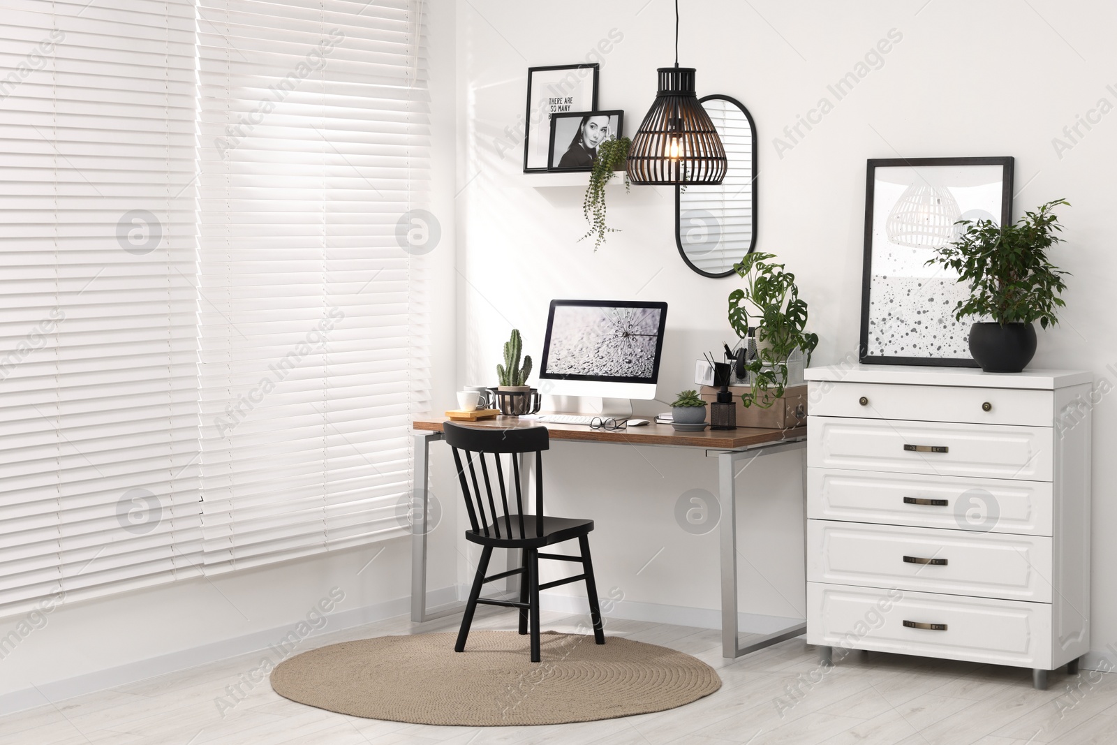 Photo of Cozy workspace with computer on wooden desk at home