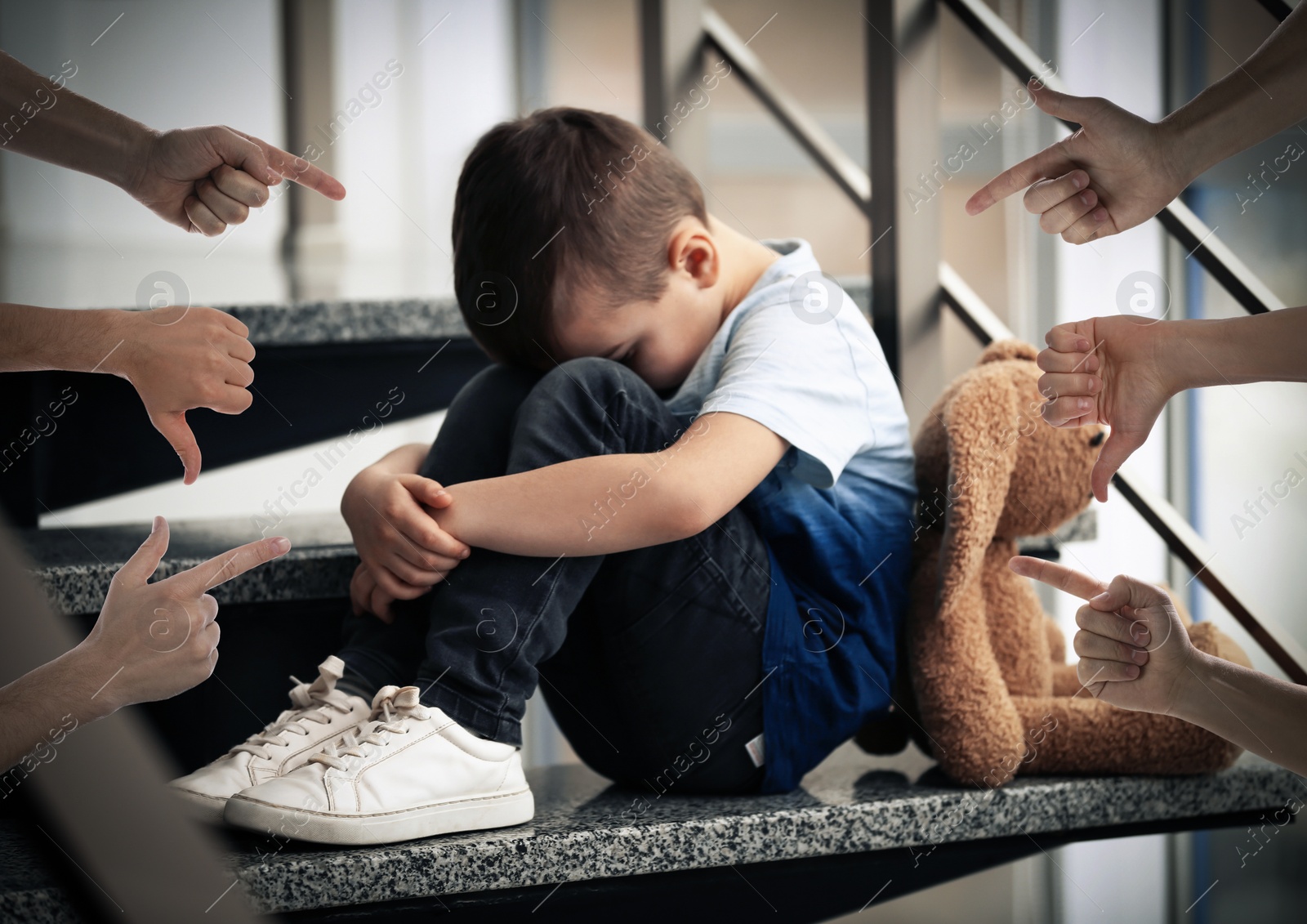 Image of People bullying little boy on stairs indoors