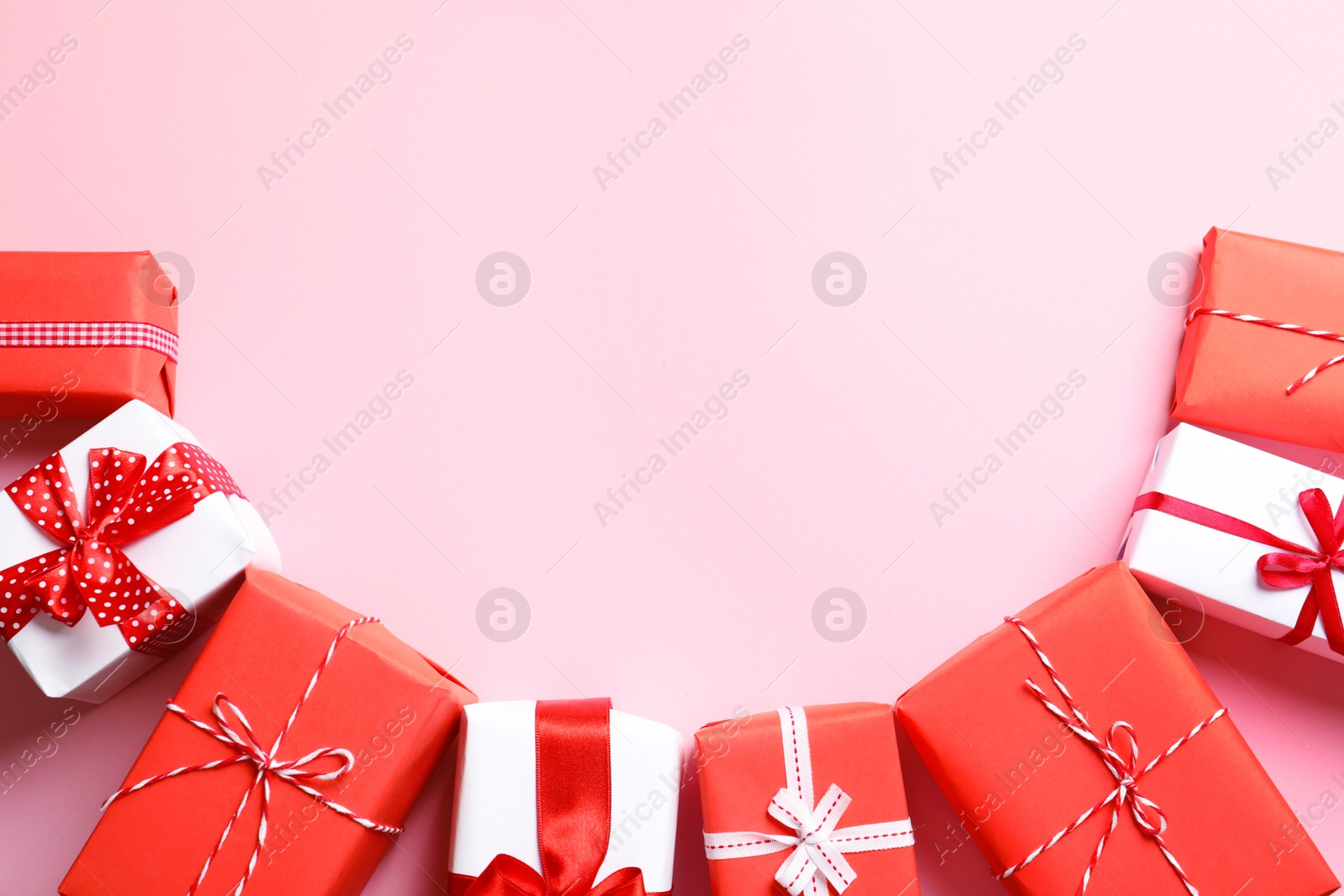 Photo of Beautifully wrapped gift boxes on color background, top view