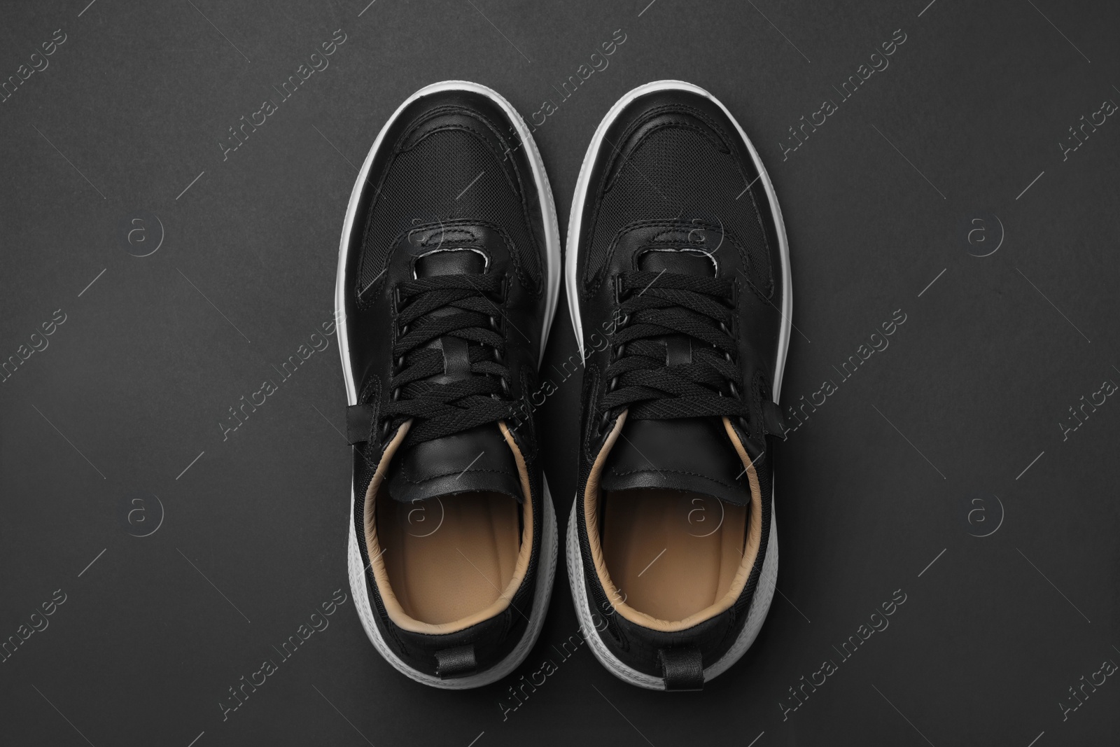 Photo of Pair of stylish shoes on black background, top view