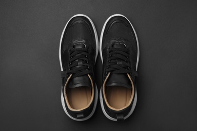 Photo of Pair of stylish shoes on black background, top view