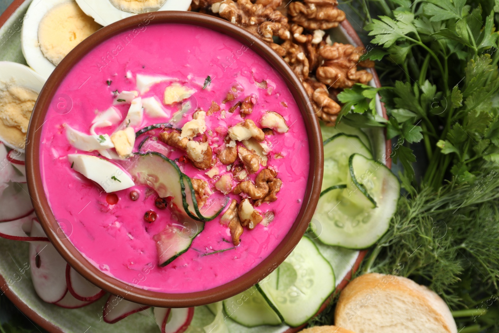 Photo of Delicious cold summer beet soup in bowl, flat lay