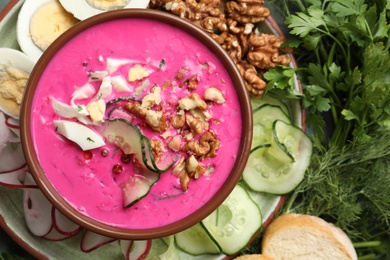 Delicious cold summer beet soup in bowl, flat lay