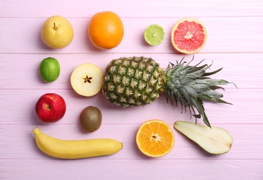 Set of fresh tropical fruits on color background