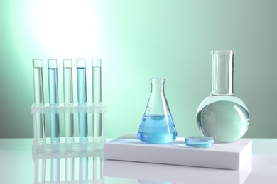 Laboratory analysis. Different glassware on table against light background