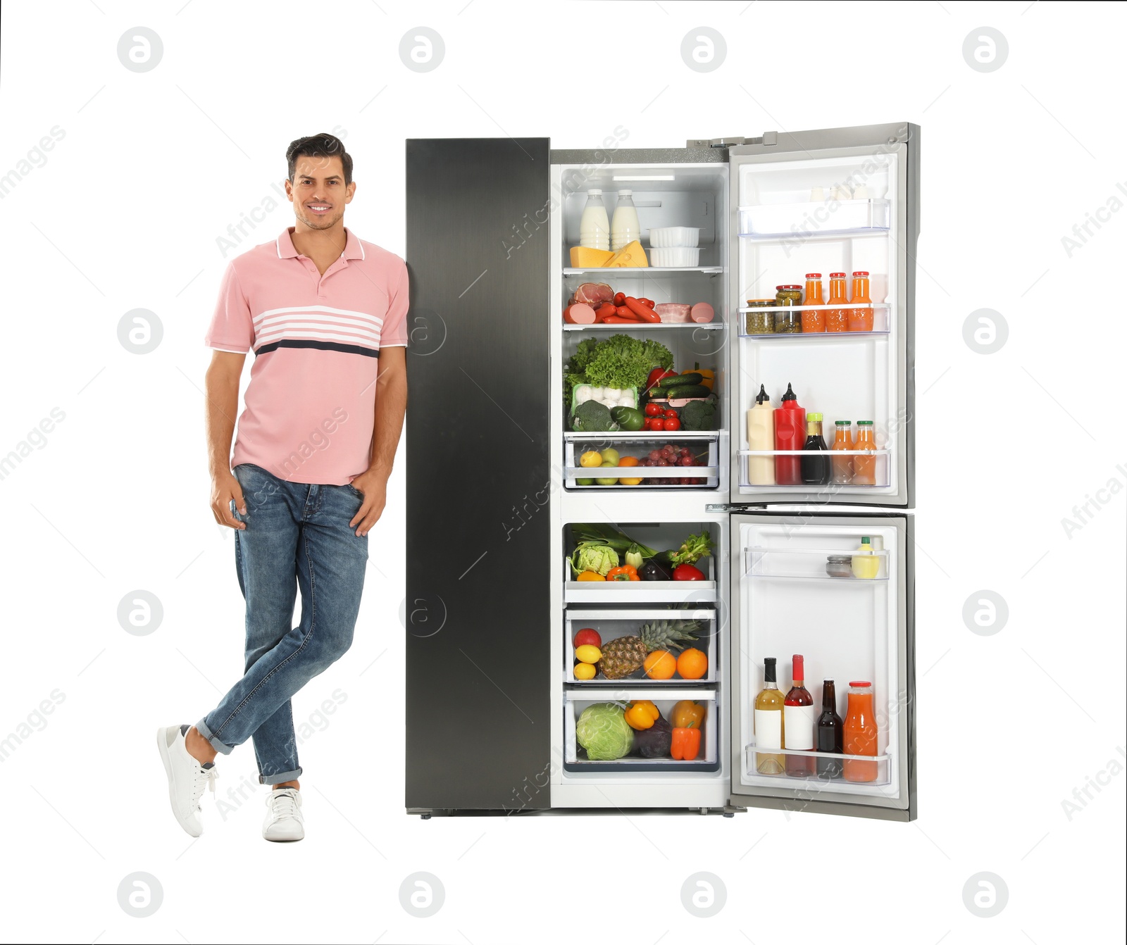 Photo of Man near open refrigerator on white background