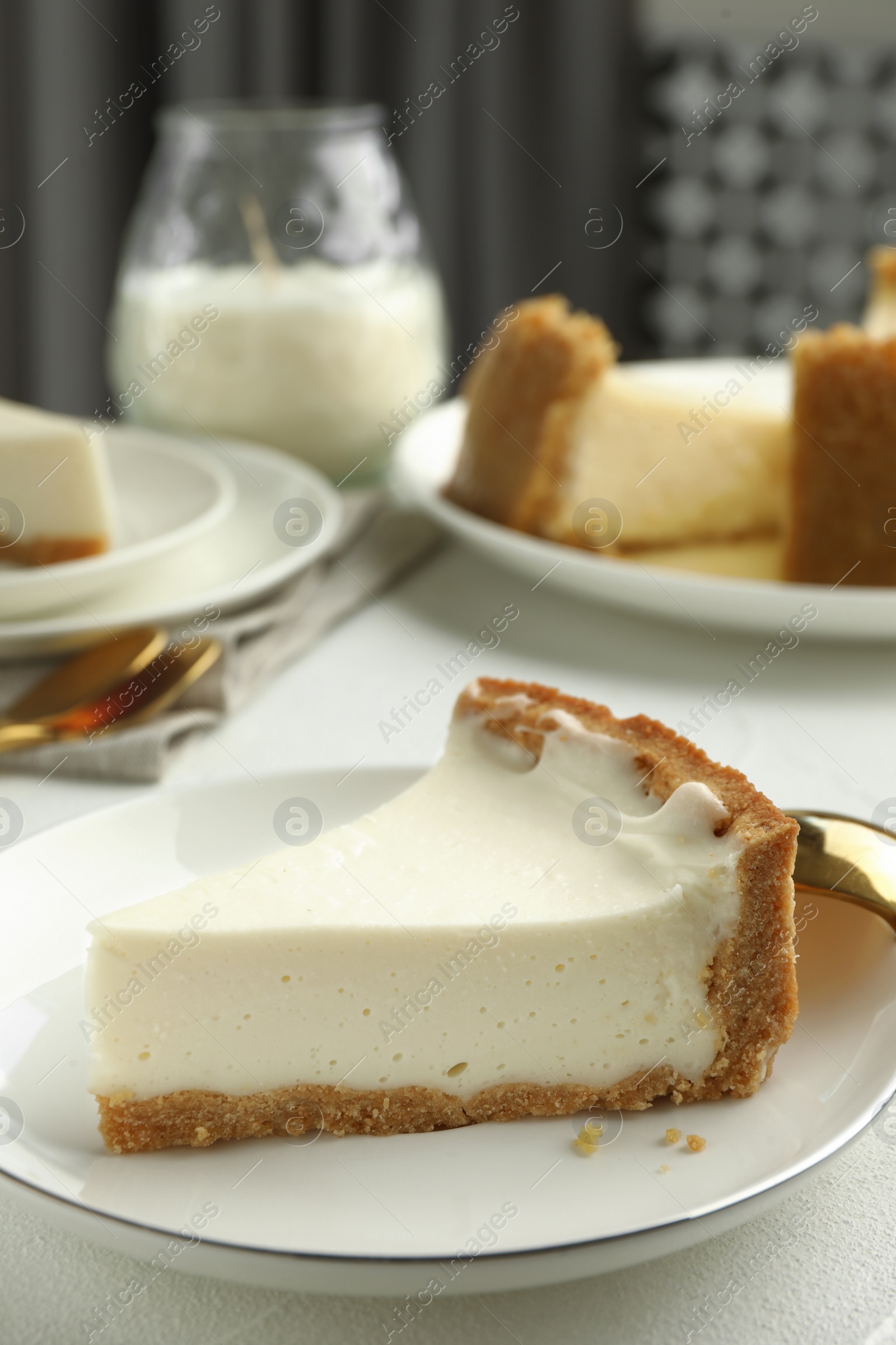 Photo of Piece of tasty vegan tofu cheesecake on white table, closeup. Space for text