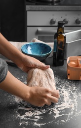 Photo of Woman kneading dough for pastry on table