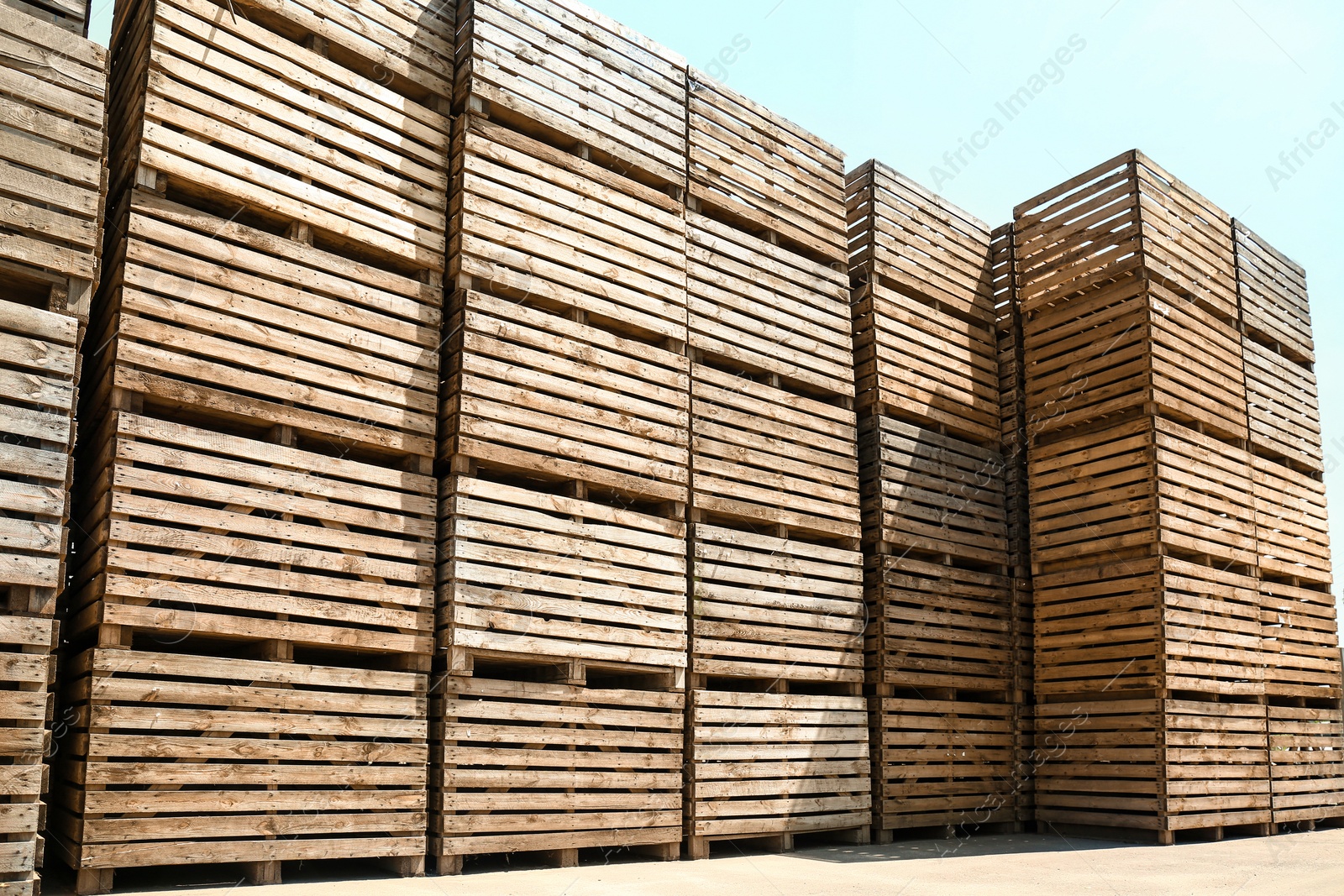 Photo of Pile of empty wooden crates outdoors on sunny day