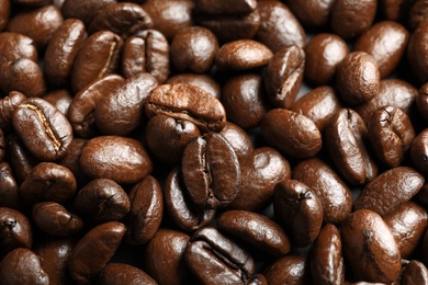 Roasted coffee beans as background, top view