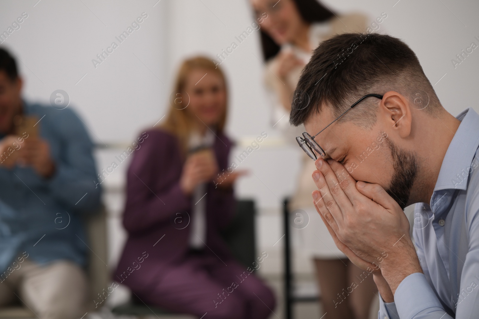 Photo of Coworkers bullying their colleague in office, space for text