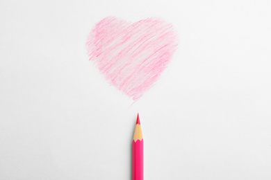 Photo of Drawing of heart and pink pencil on white background, top view