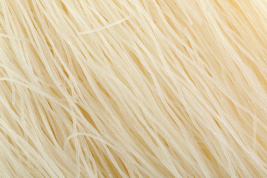 Photo of Raw rice noodles as background, closeup view