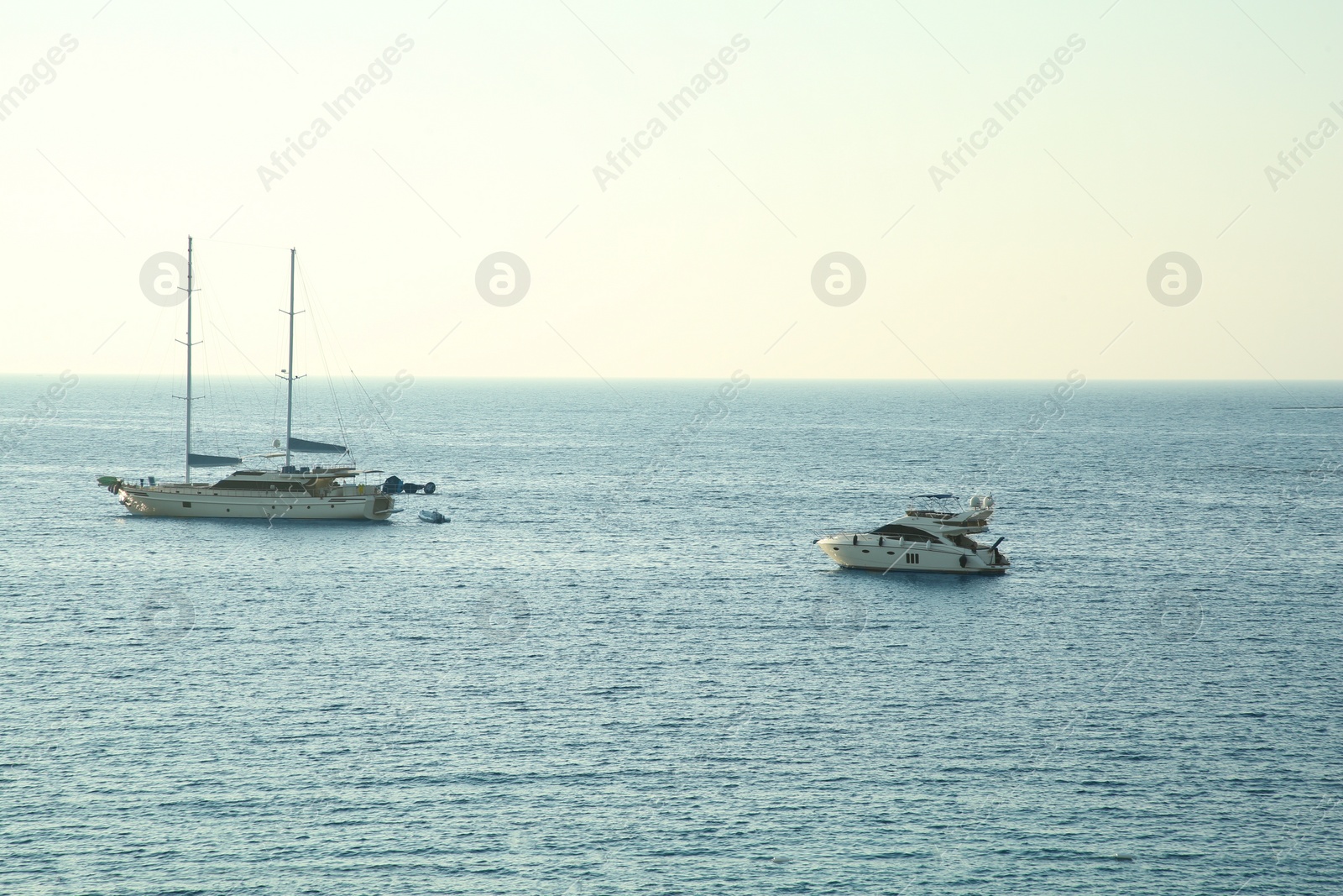 Photo of Picturesque view of calm sea with yacht and boats on summer day