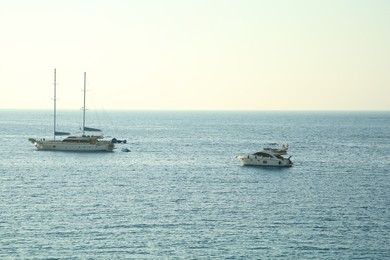 Photo of Picturesque view of calm sea with yacht and boats on summer day